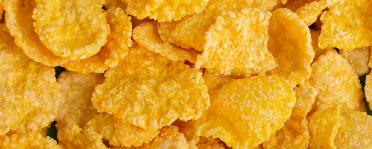 Close-up of golden yellow cornflakes, reminiscent of crispy Emping Melinjo snacks from Indonesia. | Emping SG