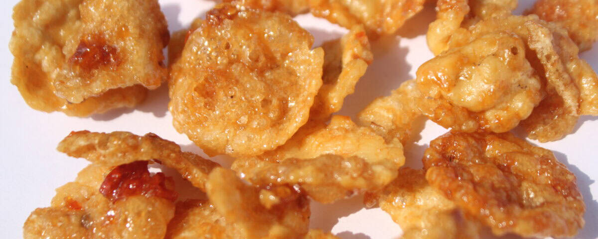Close-up of cornflake biscuits and Premium Quality Melinjo Crisps, both glazed with honey and showing a crispy, golden-brown texture. | Emping SG