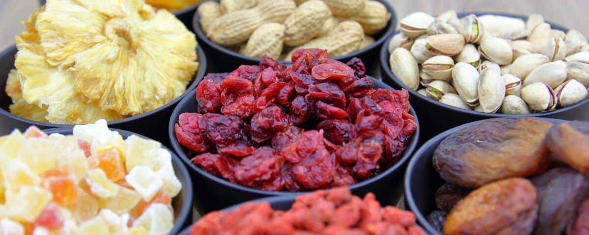Bowls filled with various dried fruit and nuts, perfect for nutritious snacking and a taste of tropical dried fruit. | Emping SG