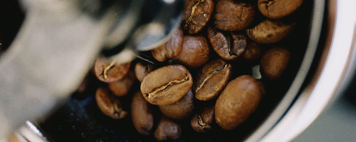 Close-up of best coffee beans inside a metal grinder, capturing rich detail—perfect for your home brewing set-up. | Emping SG