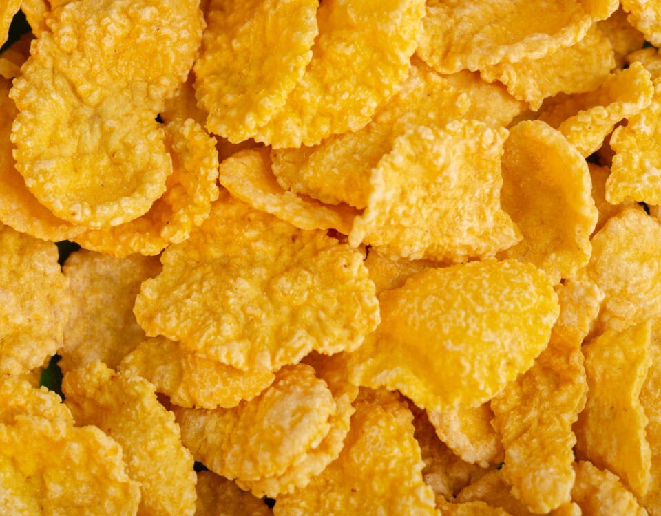 Close-up of golden yellow cornflakes, reminiscent of crispy Emping Melinjo snacks from Indonesia. | Emping SG