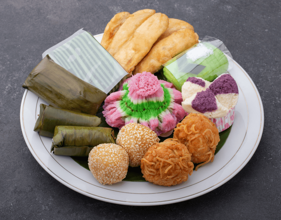 A white plate with authentic Indonesian snacks—assorted fried, steamed, and wrapped treats with timeless appeal. | Emping SG