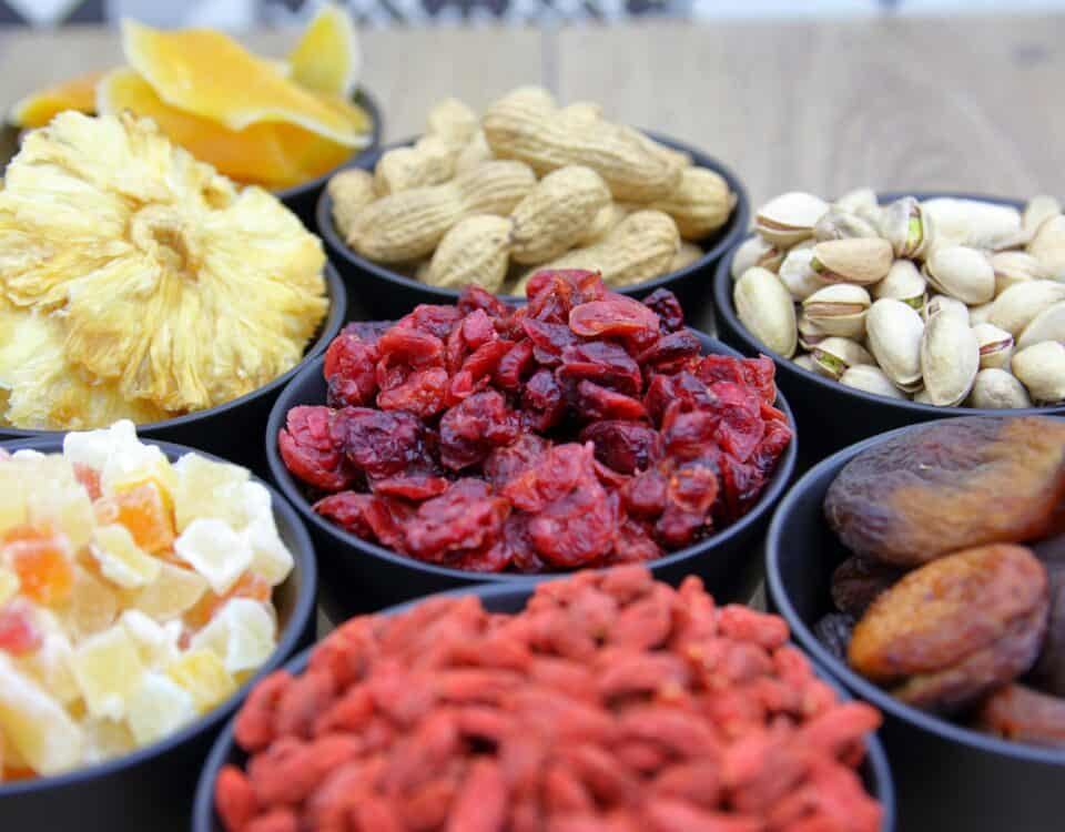 Bowls filled with various dried fruit and nuts, perfect for nutritious snacking and a taste of tropical dried fruit. | Emping SG