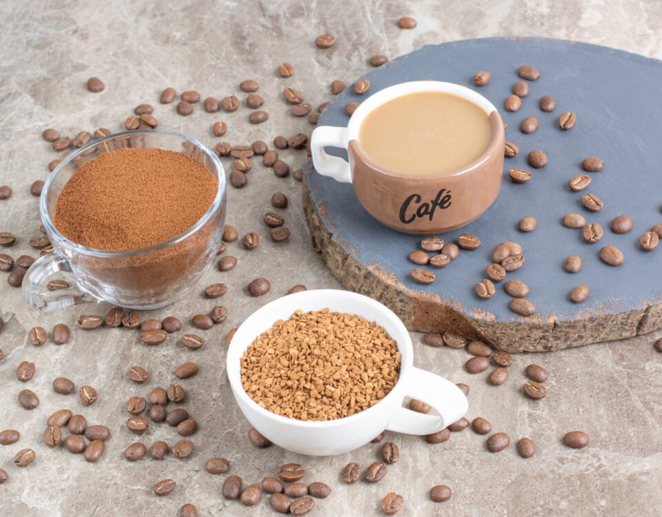 Three cups show coffee beans, instant coffee, and a mug—perfect for drinking coffee and enjoying its health benefits. | Emping SG